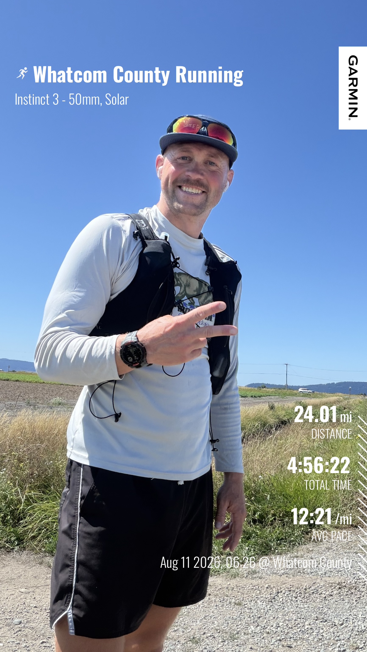 Matthew smiling beside the road after a 24-mile run through Whatcom County under a clear blue sky.