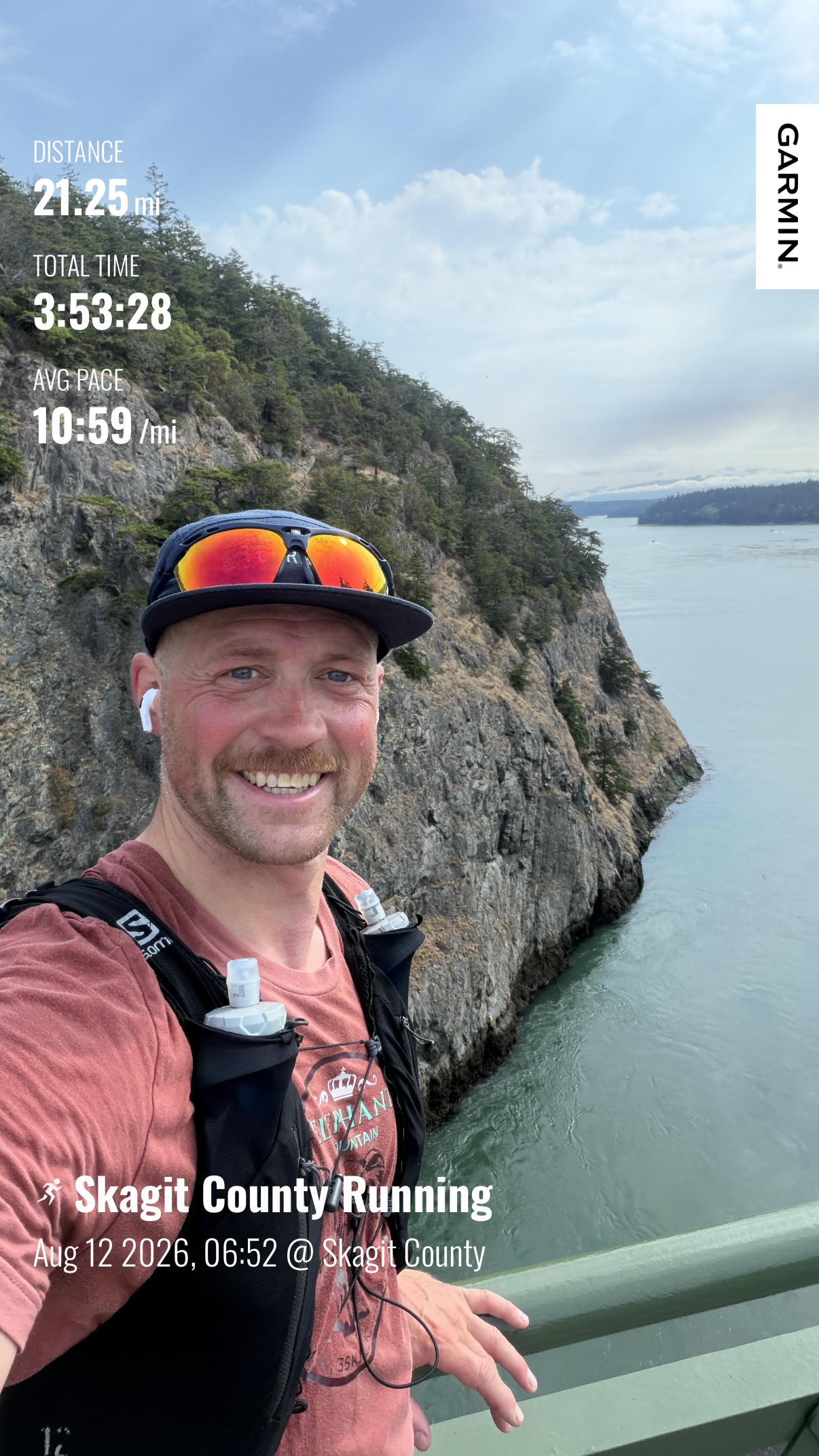 Matthew smiling above the water at Deception Pass after running 21.25 miles on Day 3