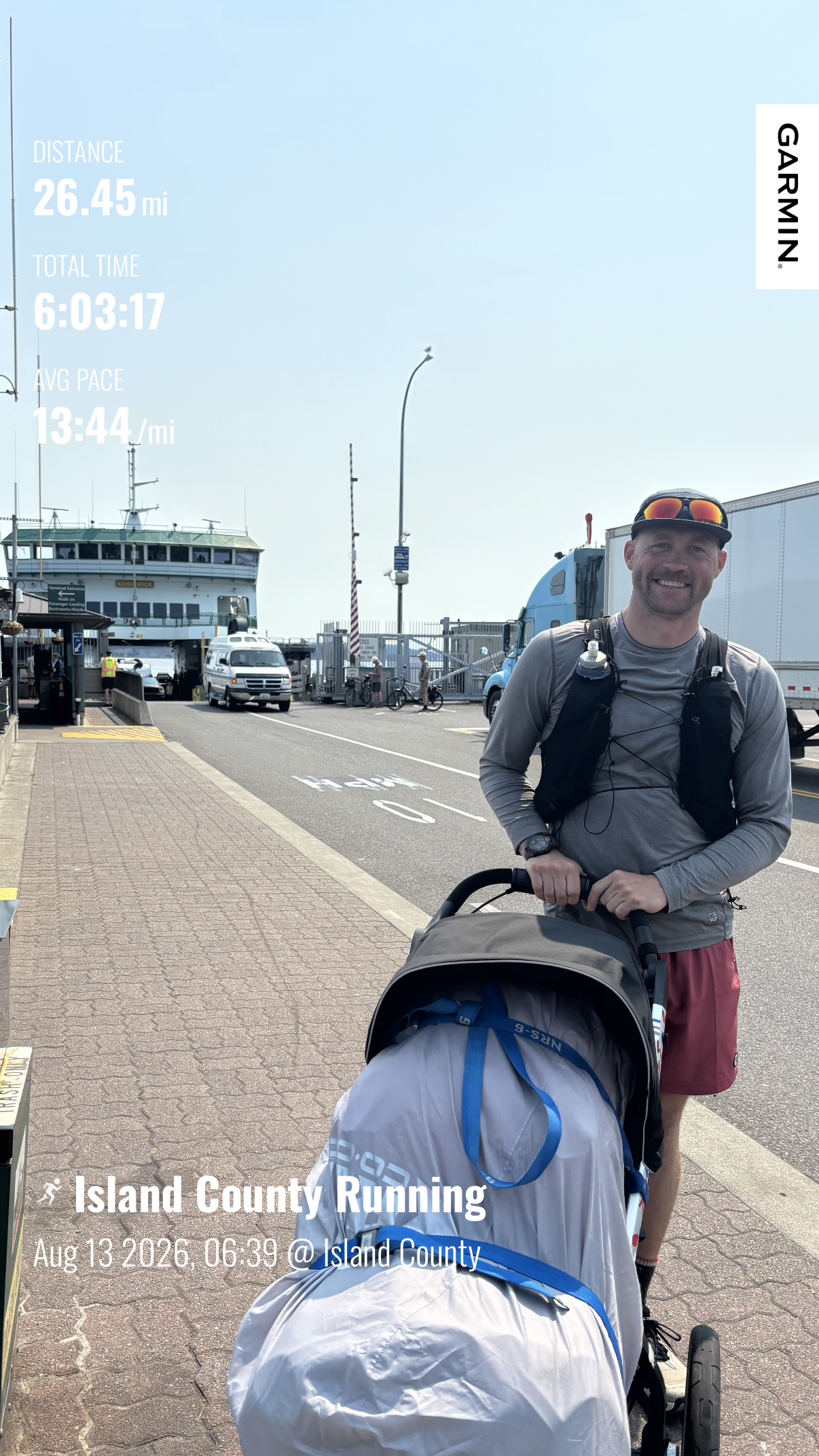 Matthew smiling with his loaded running stroller at the Whidbey Island ferry terminal after running 26.45 miles on Day 4