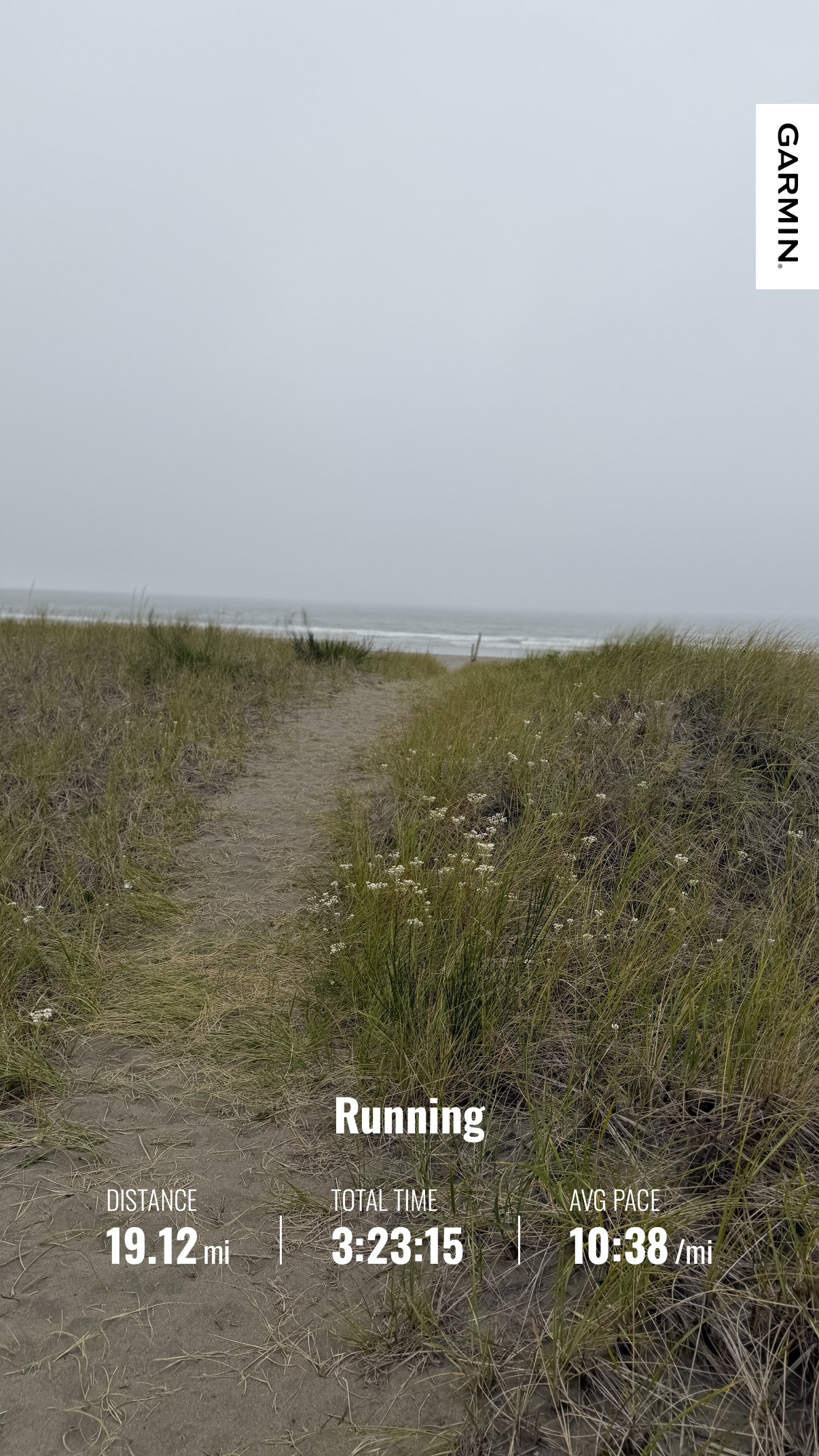 A sandy path through coastal grass leading toward the beach at Twin Harbors State Park after Matthew’s 19.12-mile run
