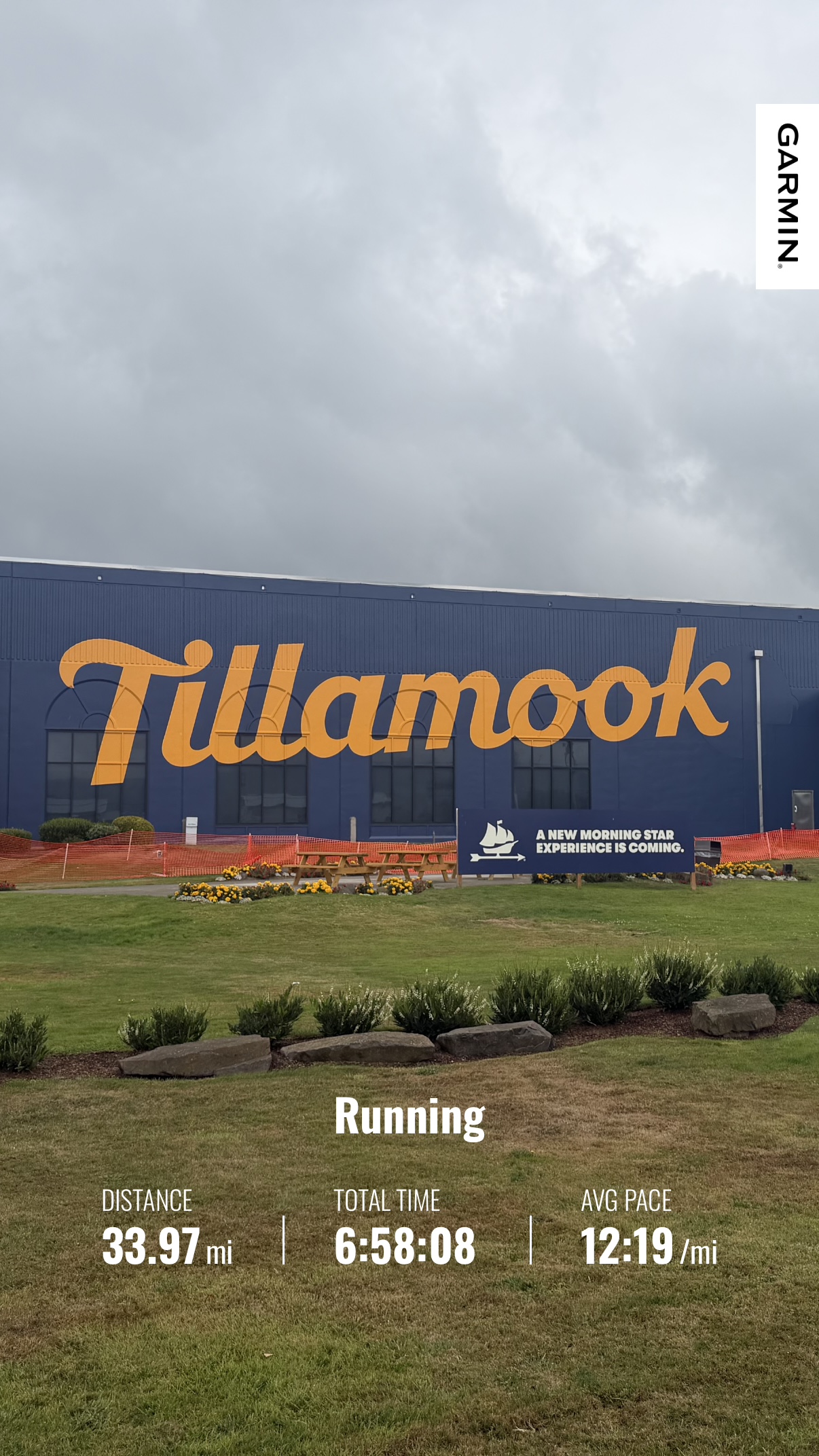 Tillamook Creamery beneath cloudy skies with Matthew’s Garmin summary showing a 33.97-mile run from Manzanita to Netarts