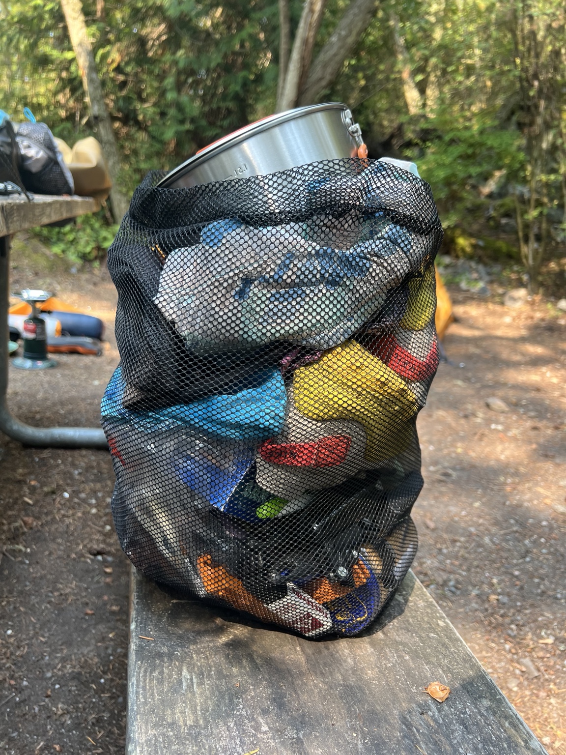 A mesh bag filled with running and camping gear at Deception Pass State Park