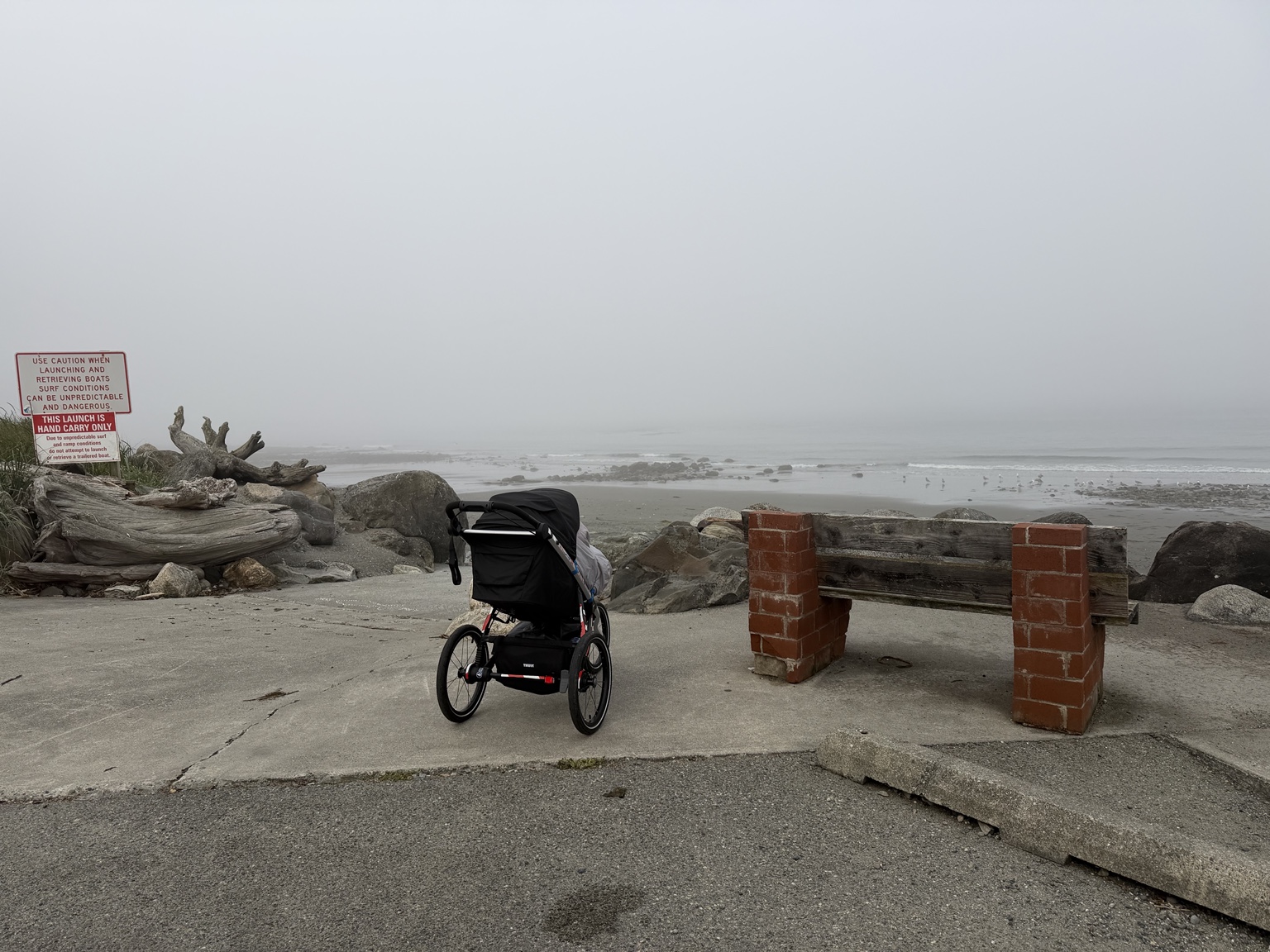 The running stroller beside a foggy beach along the coast