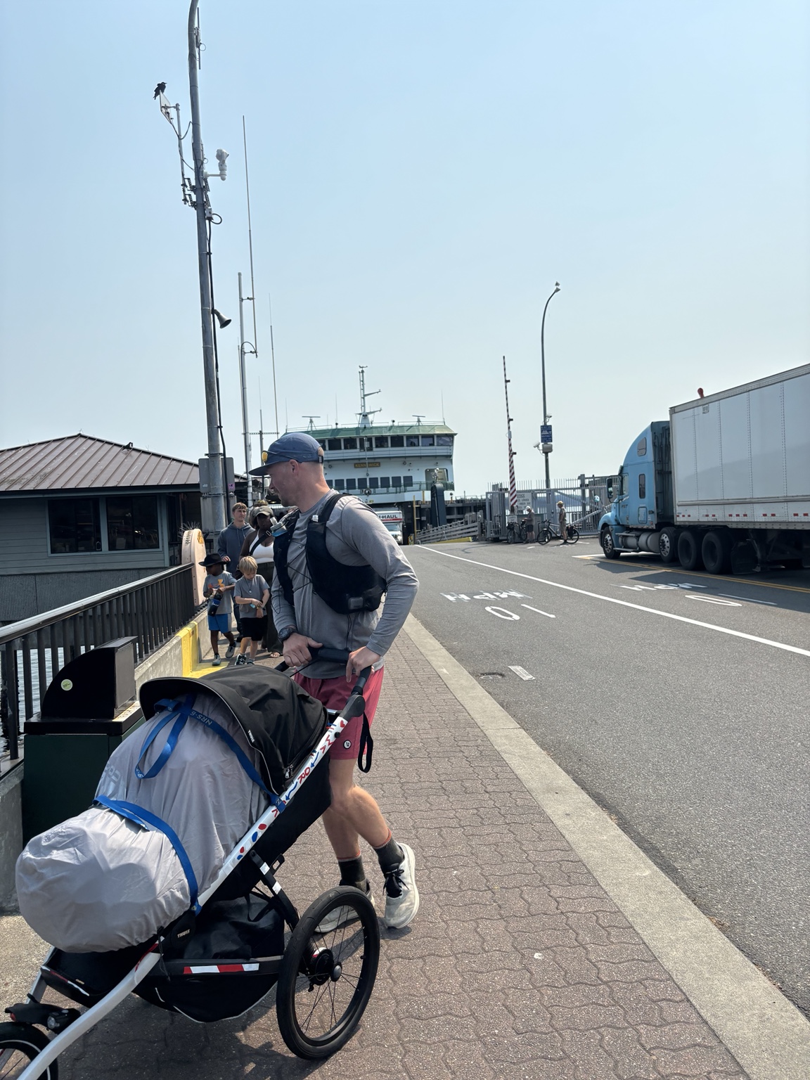 Matthew pushing his loaded running stroller beside the ferry terminal