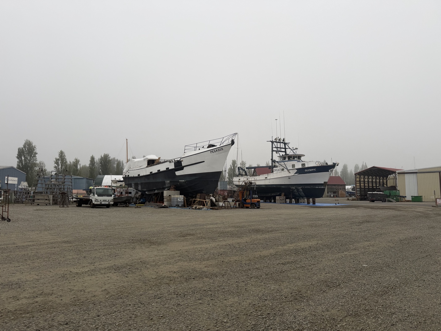 Fishing boats hauled out in a foggy Olympic Peninsula boatyard