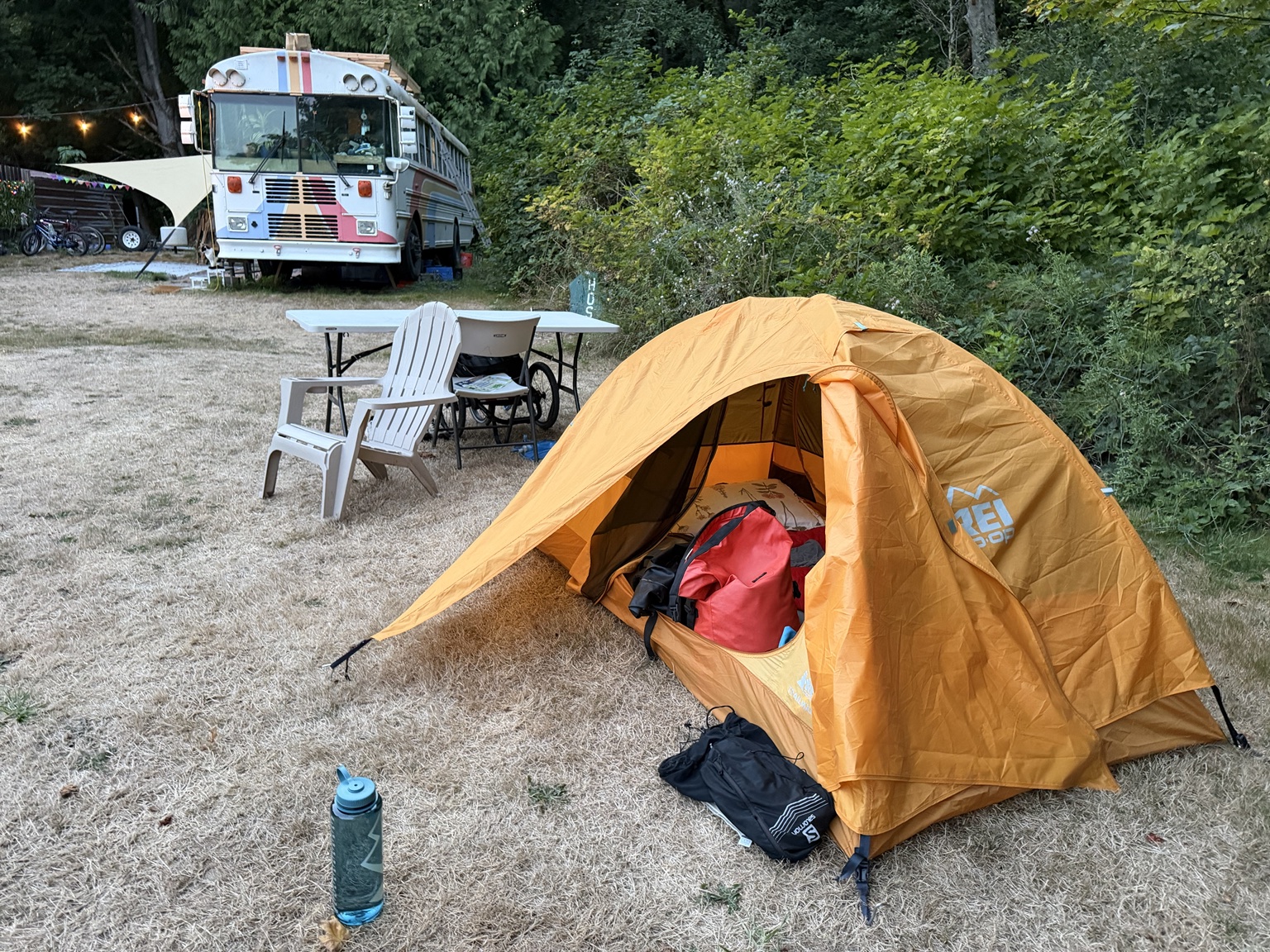 Matthew’s orange tent at camp beside a converted bus