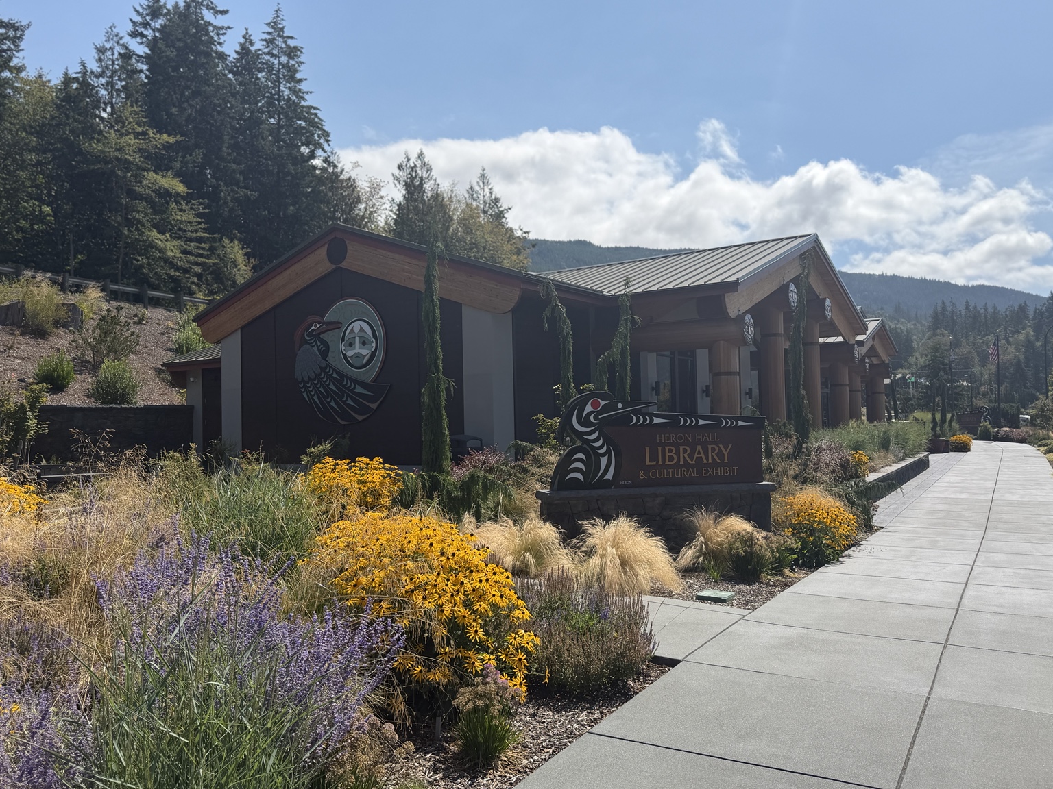 Heron Hall Library and Cultural Exhibit surrounded by flowers