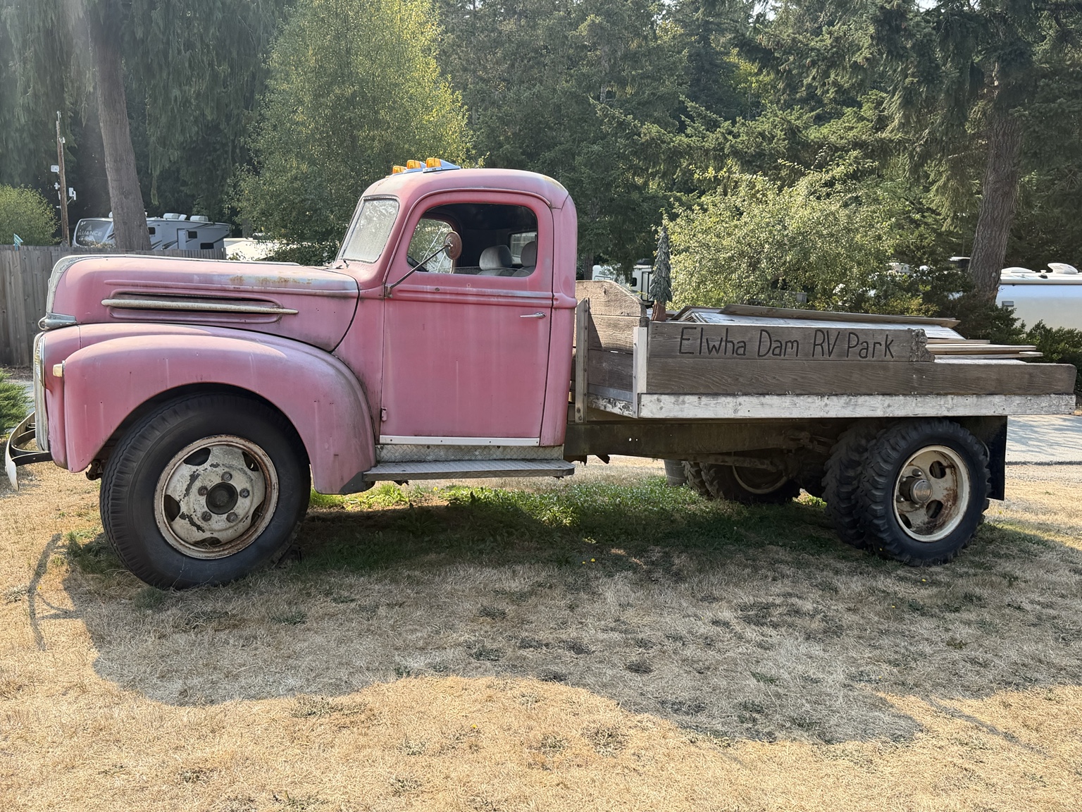 A vintage pink truck marking the entrance to Elwha Dam RV Park