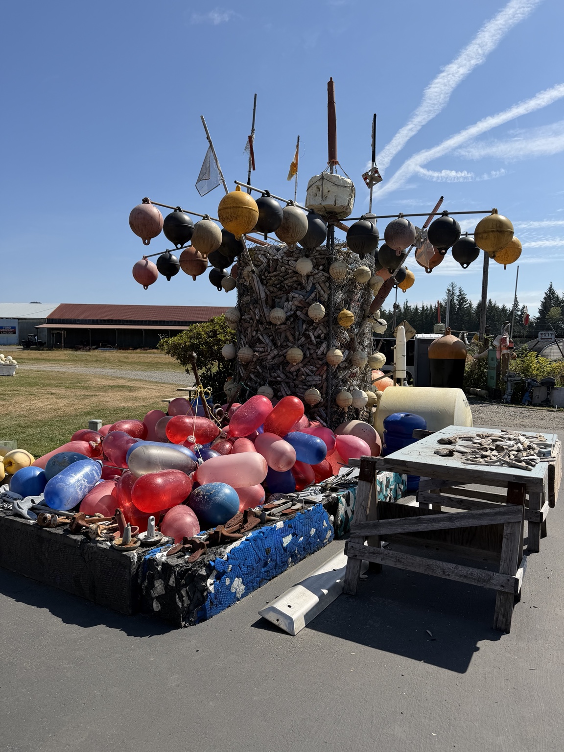 A colorful outdoor sculpture made from fishing floats and marine debris