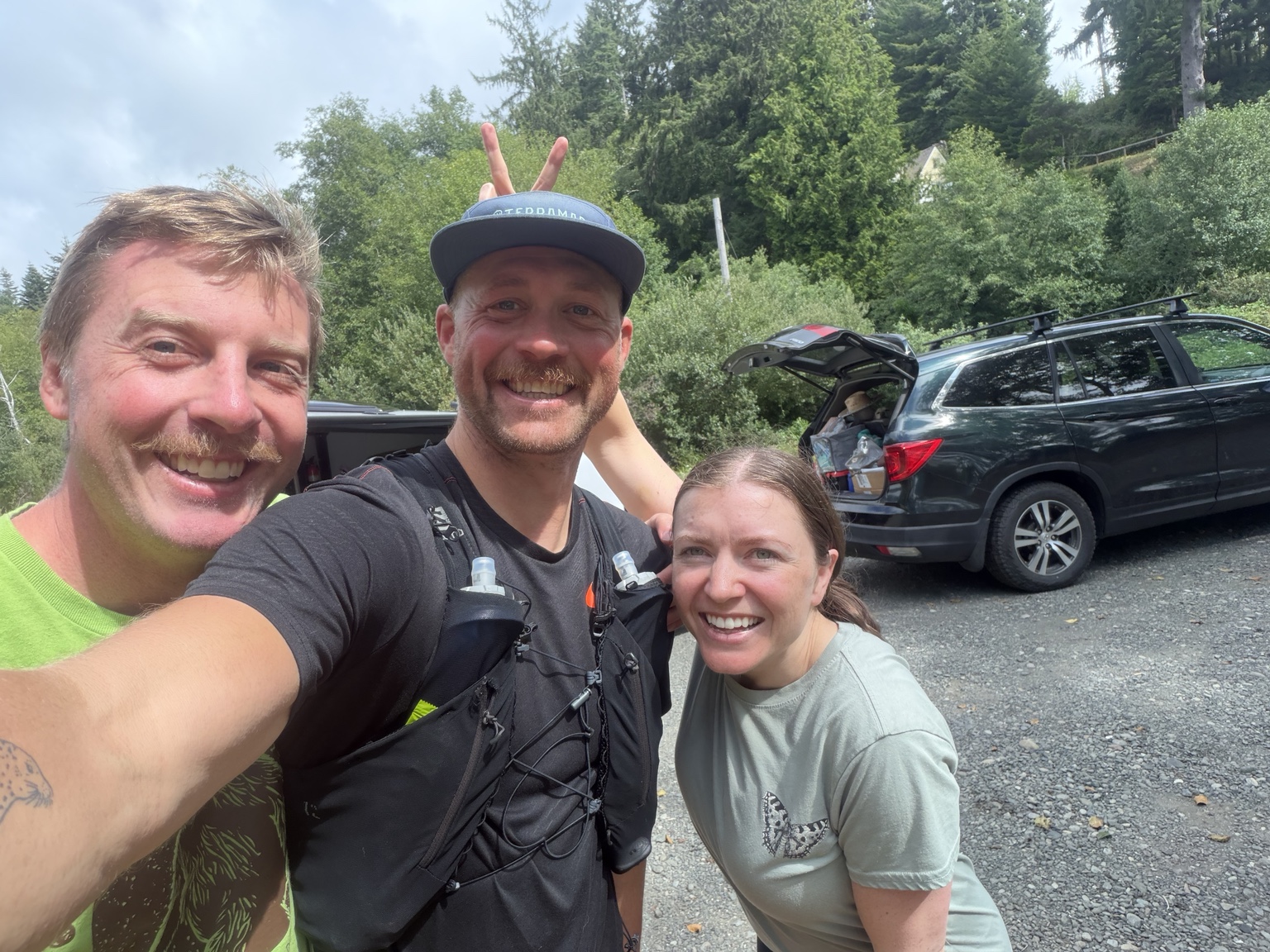 Matthew smiling with his former rugby teammate and his wife during a roadside reunion