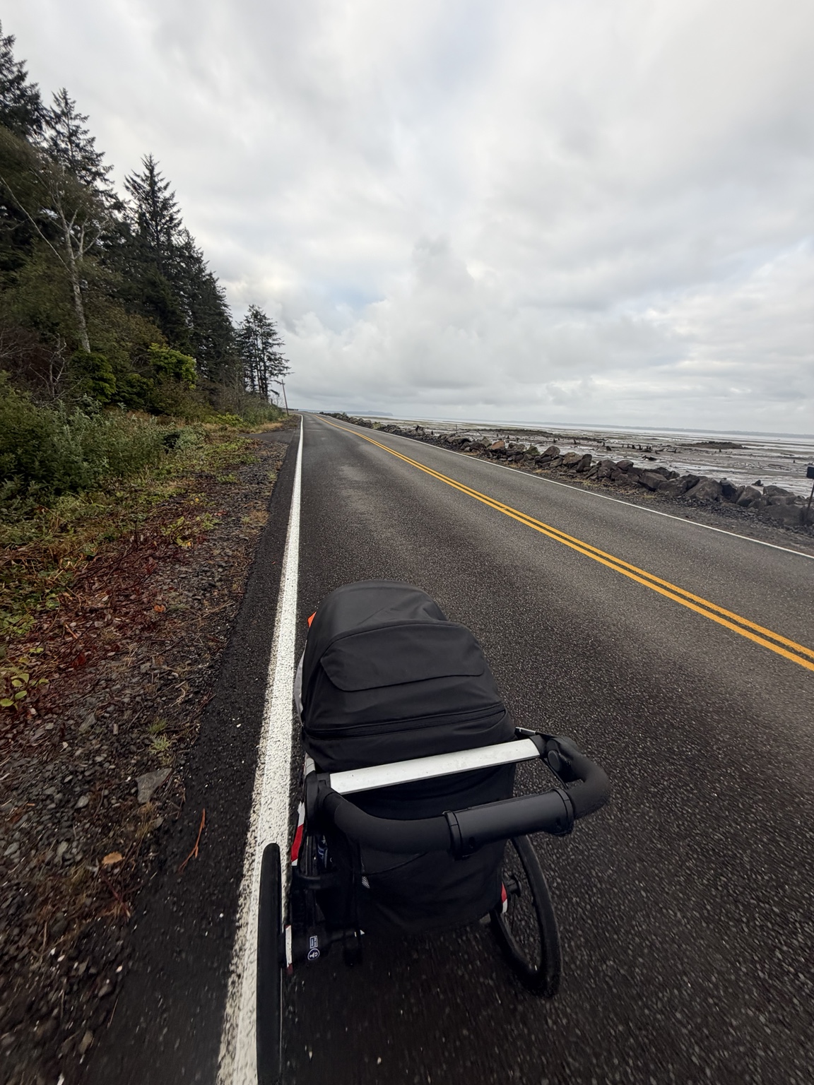 Matthew’s running stroller beside a coastal road with waves breaking along the shore