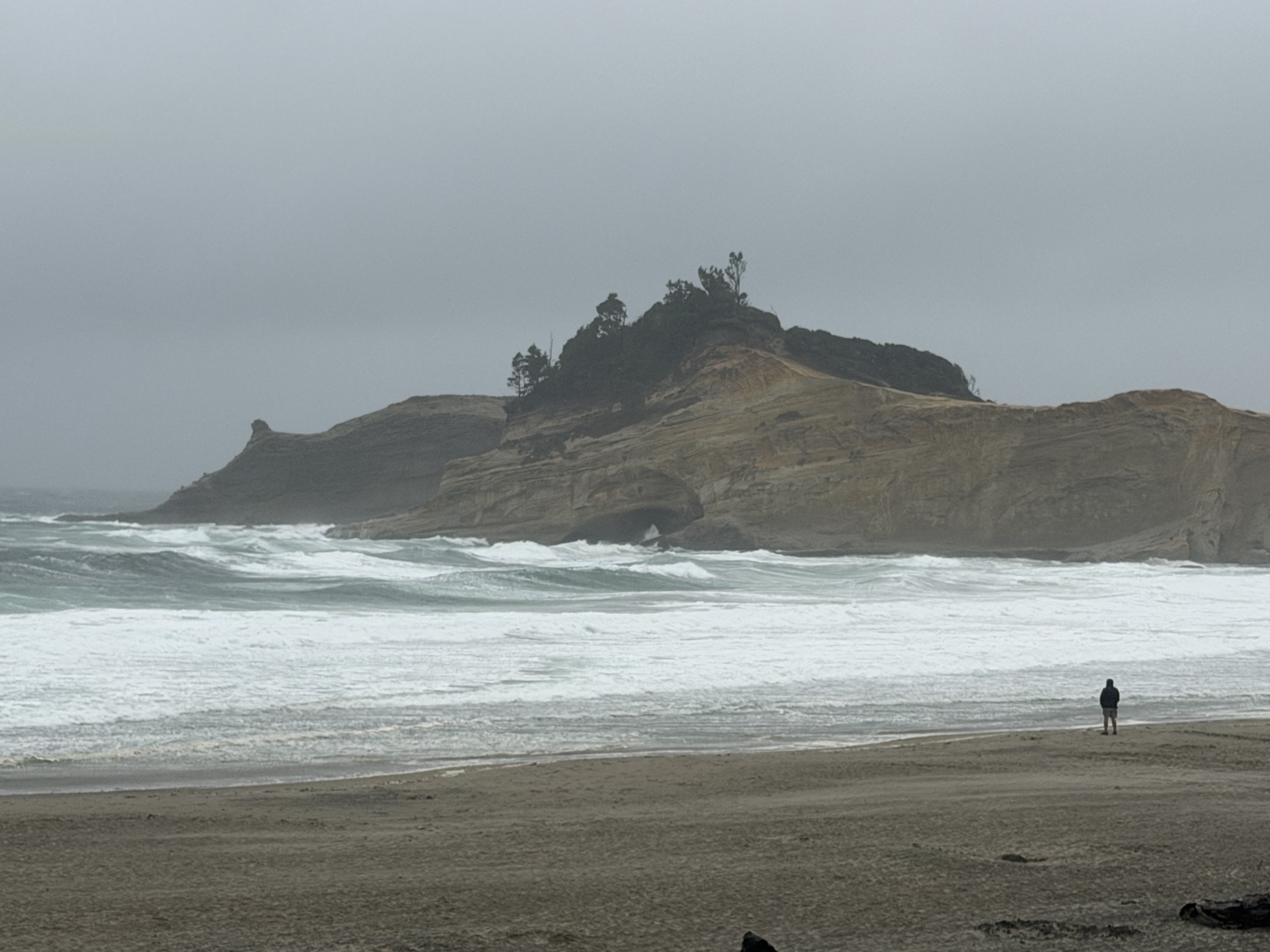 Stormy waves breaking beneath the sandstone cliffs at Cape Kiwanda in Pacific City