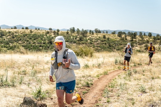 Matthew trail running through an open landscape