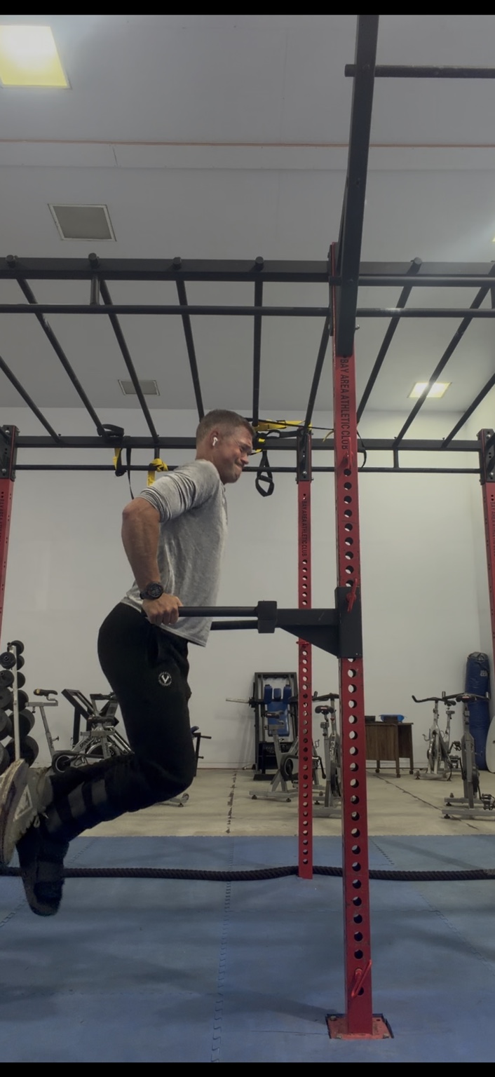 Matthew doing dips during an ankle rehabilitation workout at the gym